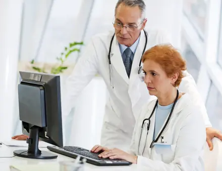 Colleagues collaborating at a computer